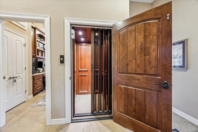 hallway with baseboards and light tile patterned flooring