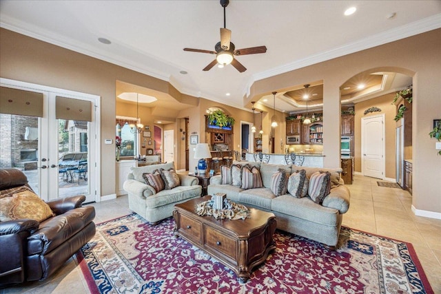 living area with arched walkways, french doors, light tile patterned flooring, and crown molding