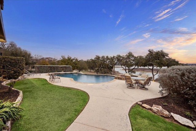 outdoor pool featuring a patio area and a yard