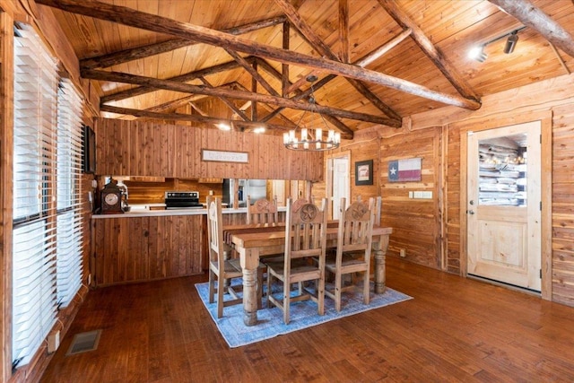 116 Yucca Ln, Bastrop, TX 78602 - dining space with wooden ceiling, dark wood-style floors, wood walls, a chandelier, and track lighting