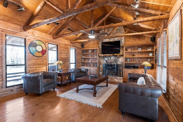 living room with vaulted ceiling with beams, wood-type flooring, wood ceiling, and wooden walls