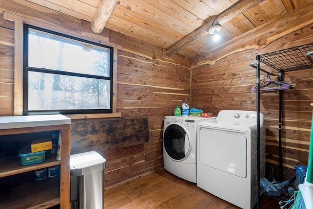 laundry area with wood ceiling, washing machine and dryer, laundry area, and wooden walls