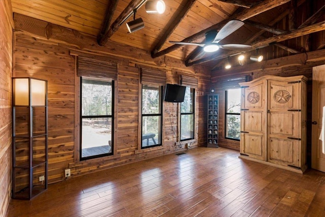 116 Yucca Ln, Bastrop, TX 78602 - spare room featuring wooden ceiling, wood walls, plenty of natural light, dark wood-style floors, and a ceiling fan