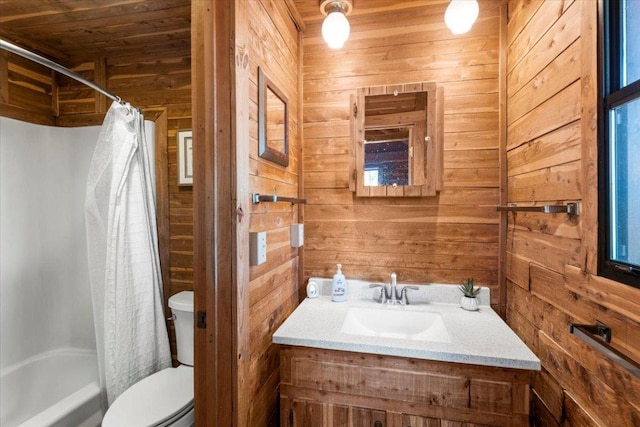 full bath with toilet, wood walls, shower / bathtub combination with curtain, and vanity