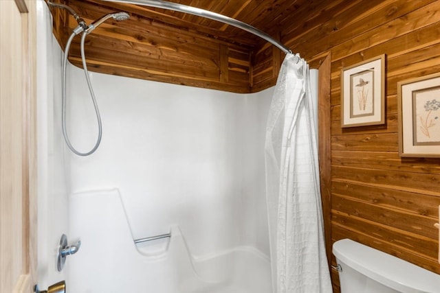 full bathroom featuring toilet, wood walls, and wood ceiling