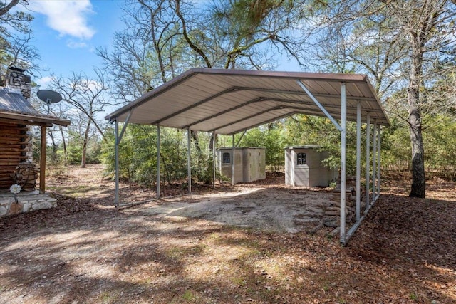 view of parking / parking lot featuring a shed, dirt driveway, and a carport