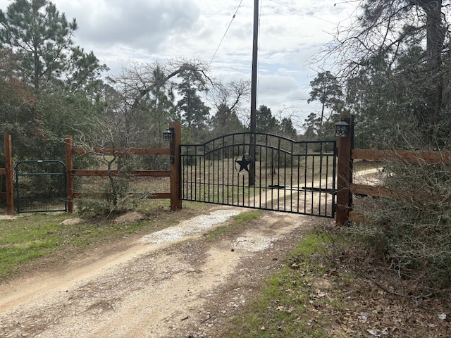 view of gate with fence