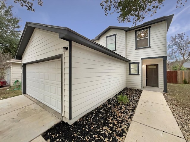 view of front of property with fence and an attached garage