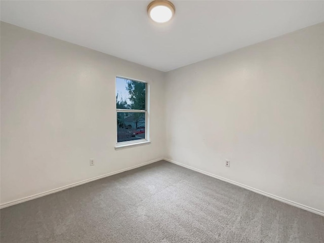 spare room with carpet flooring and baseboards