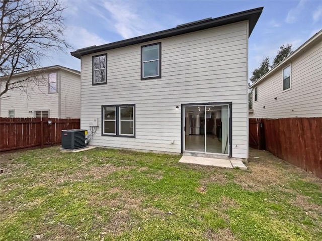 back of house featuring a lawn, cooling unit, and a fenced backyard