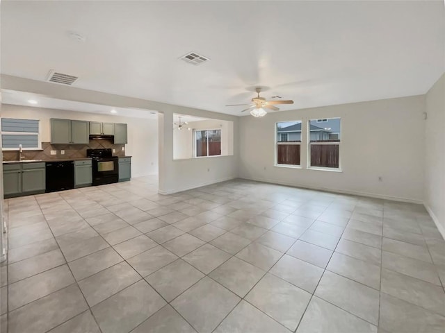 unfurnished living room featuring light tile patterned flooring, visible vents, baseboards, and ceiling fan with notable chandelier