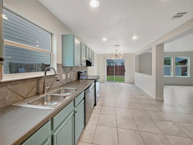 kitchen featuring a sink, visible vents, stainless steel dishwasher, decorative backsplash, and electric range oven