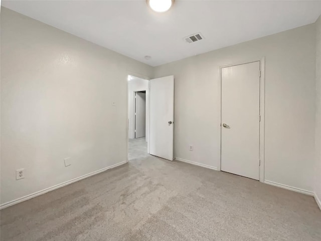 unfurnished bedroom with carpet flooring, visible vents, and baseboards