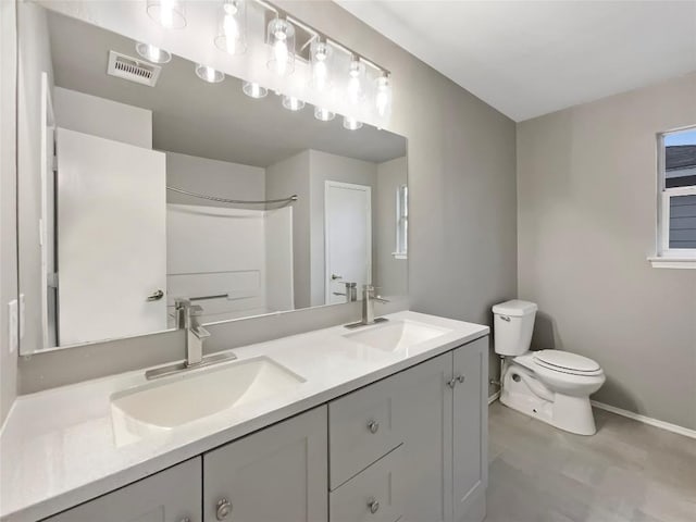 full bathroom with visible vents, a sink, toilet, and double vanity