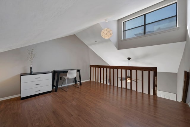 additional living space featuring lofted ceiling, wood finished floors, and baseboards