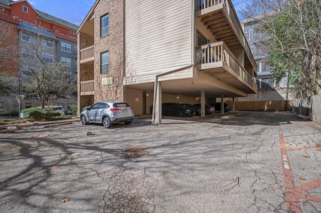 exterior space featuring uncovered parking and brick siding