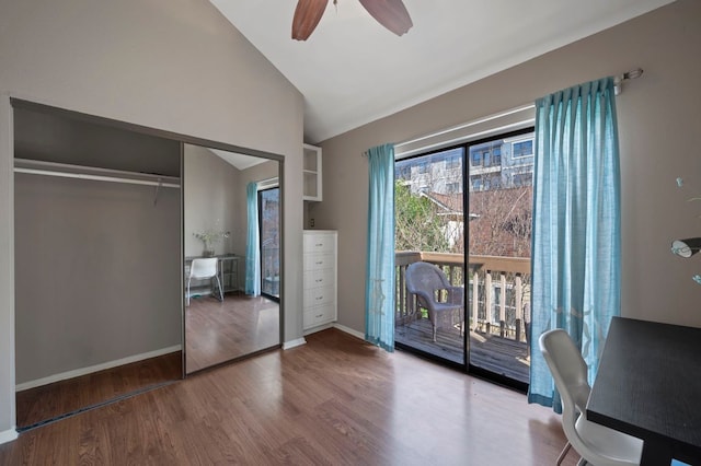 unfurnished bedroom with baseboards, wood finished floors, access to exterior, vaulted ceiling, and a closet