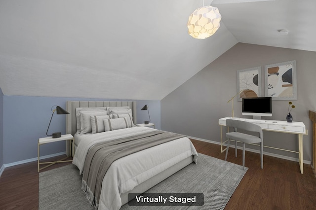 bedroom featuring vaulted ceiling, baseboards, and wood finished floors