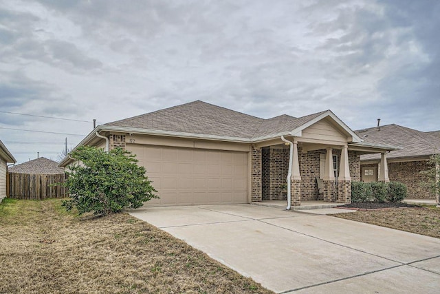 112 Quarton Dr, Hutto, TX 78634 - view of front of home with an attached garage, a porch, concrete driveway, and brick siding