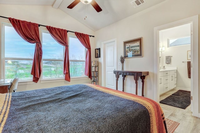 bedroom with lofted ceiling with beams, multiple windows, visible vents, and ensuite bathroom