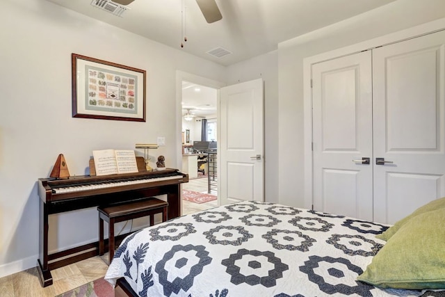 bedroom featuring a ceiling fan, a closet, visible vents, and light wood-style floors