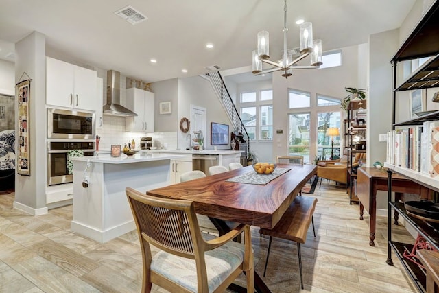 dining room featuring a chandelier, stairway, visible vents, and recessed lighting