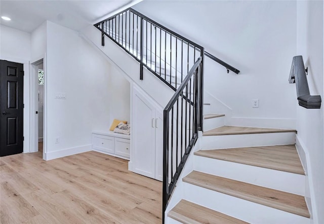 5408 Downs Dr Unit 2, Austin, TX 78721 - stairway featuring baseboards, wood finished floors, and recessed lighting