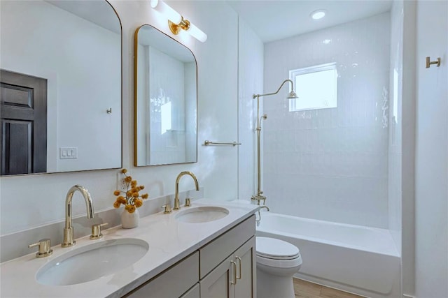 full bathroom featuring shower / bath combination, a sink, toilet, and double vanity