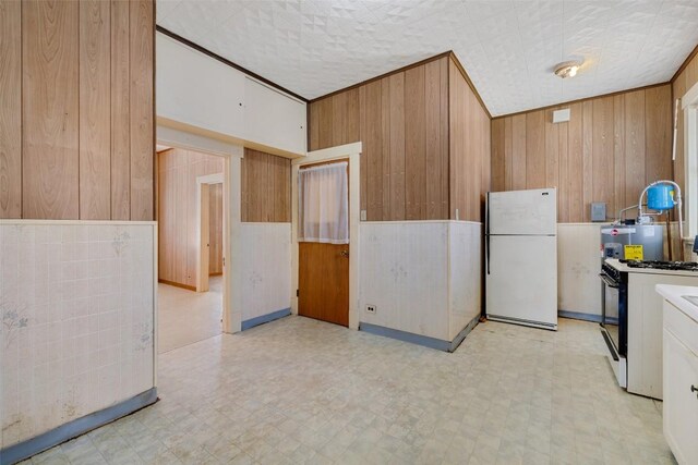 washroom with light floors and wooden walls