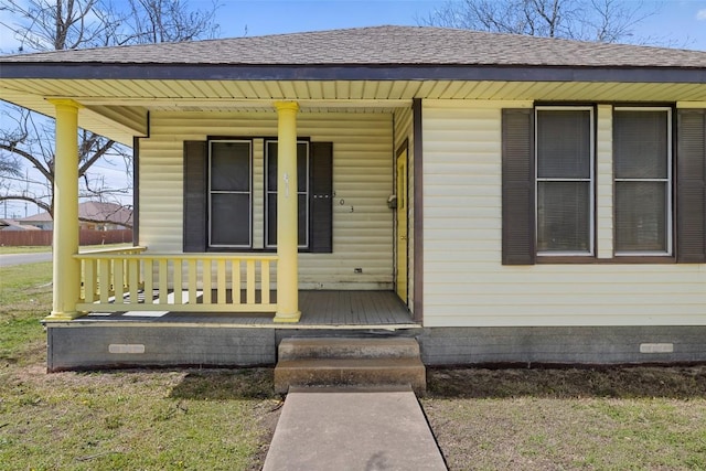 doorway to property with a porch, crawl space, and a shingled roof