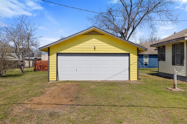 detached garage featuring fence