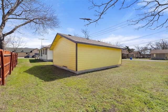 view of property exterior featuring fence and a lawn