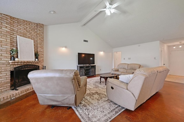 living room featuring beamed ceiling, a textured ceiling, a ceiling fan, visible vents, and a brick fireplace
