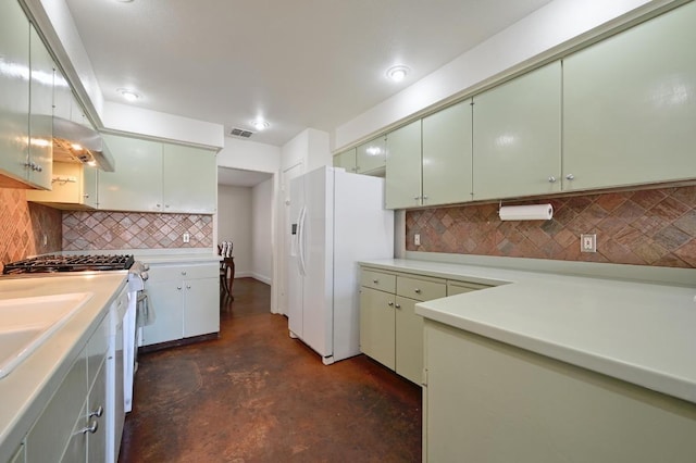 kitchen featuring white fridge with ice dispenser, light countertops, visible vents, range with gas cooktop, and decorative backsplash