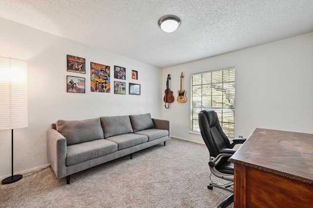 carpeted office featuring a textured ceiling and baseboards