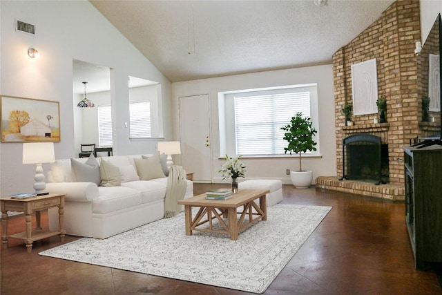 living area featuring visible vents, a textured ceiling, a brick fireplace, and lofted ceiling