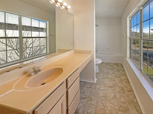 full bath featuring baseboards, toilet, an inviting chandelier, tub / shower combination, and vanity