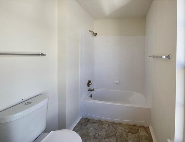 full bathroom featuring toilet, baseboards, and shower / bathing tub combination