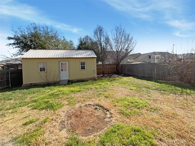 view of yard with an outbuilding and a fenced backyard