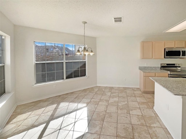 kitchen featuring light brown cabinets, stainless steel appliances, visible vents, light countertops, and an inviting chandelier