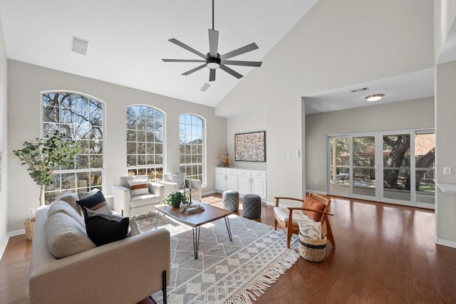 living room featuring high vaulted ceiling, baseboards, a ceiling fan, and wood finished floors