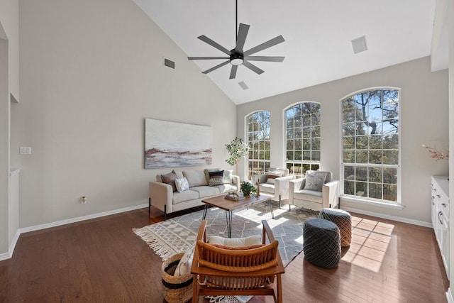 living room featuring high vaulted ceiling, a ceiling fan, visible vents, and wood finished floors