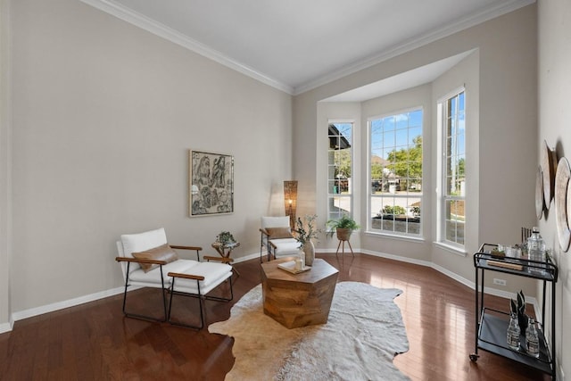 sitting room featuring crown molding, wood finished floors, and baseboards