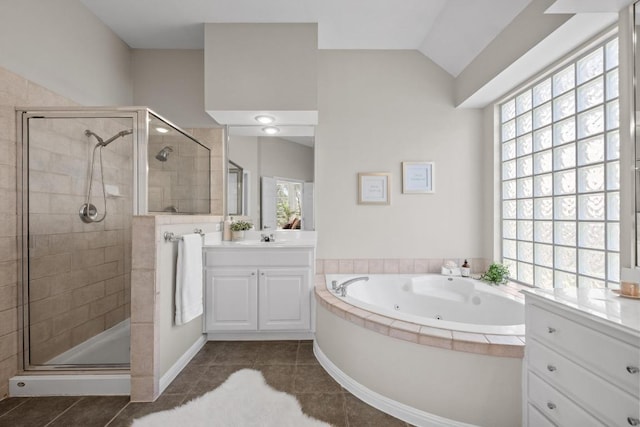 bathroom with lofted ceiling, a stall shower, plenty of natural light, and tile patterned floors