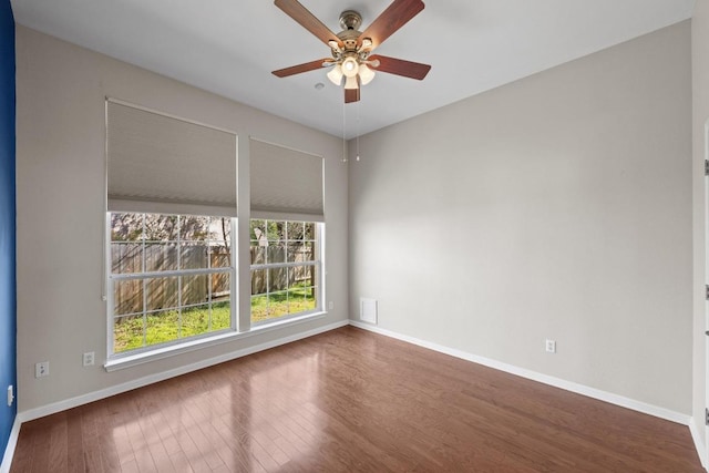 unfurnished room with ceiling fan, baseboards, and wood finished floors