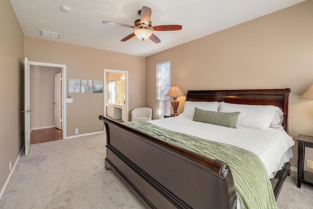 bedroom with ceiling fan, connected bathroom, light carpet, visible vents, and baseboards