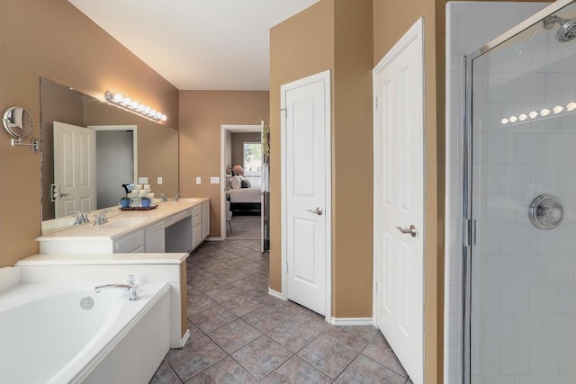 ensuite bathroom with double vanity, tile patterned floors, a garden tub, a shower stall, and a sink