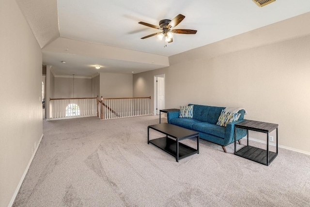 living room featuring carpet flooring, ceiling fan, visible vents, and baseboards