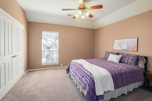 carpeted bedroom with ceiling fan, lofted ceiling, visible vents, and baseboards