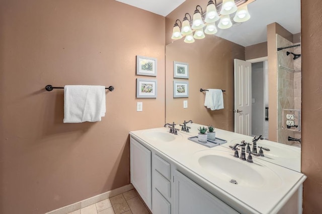 bathroom featuring double vanity, a sink, baseboards, and tile patterned floors